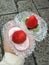 Close-up Japanese traditional dessert, daifuku or mochi, double red bean strawberry and green tea daifuku, on the hand for couple