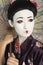 Close-up of Japanese woman with painted face holding parasol