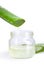 Close up jar of aloe vera gel with sliced aloe vera leaf isolated on white background with clipping path.