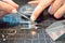 Close-up of jeweler sorting diamonds on her workbench