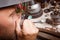 Close-up jeweler working. Craftsman making jewelry on a workshop background. Accessory making concept.