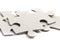 Close-up on jigsaw puzzle pieces, blank white paper jigsaw puzzle elements linked together and separate,