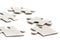 Close-up on jigsaw puzzle pieces, blank white paper jigsaw puzzle elements linked together and separate,