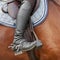 Close up of jockey riding boot, saddle and stirrup