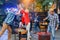 Close up of joyful guy with blond girl plays table football game while their male friend grilling vegetables in outdoors