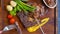 Close-up of juicy beef steak with grilled vegetables on a wooden board