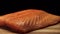 Close-up of juicy piece of salmon. Juicy fresh and red slice of salmon meat lying on wooden board on black background