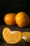 A close up of a juicy segment of an orange tangerine