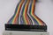 Close-up of jumper wires connected to breadboard in rainbow colors. Jumper cables for electronic project