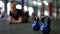 Close-up kettlebells on floor in gym with blurred fit slim woman in plank position at background. Sportive equipment