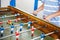 Close-up of kid boy playing table soccer. Happy excited child having fun with family game with siblings or friends
