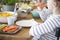 Close-up of kid eating carrot during breakfast. Healthy diet for