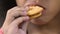 Close-up of kid eating nice crunchy cookie, many crumbs on small children\'s lips