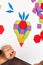 Close up of kid hands playing bright wooden tangram toy. The child collects a pattern of wooden bars. Creative baby make