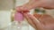 Close up kid hands using using a dispenser of cleansing solution, liquid soap for washing hands