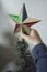 A close-up of kids hands with a Christmas ornament