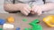 Close up of kids hands molding colorful childs play clay. Learning educational activities for children at home, in kindergarten.