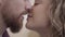 Close up kissing bearded man and pretty woman. Beautiful couple show their tenderness to each other. Lovers happy