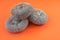 Close-up of kitchenware new metal sponges on a bright orange background. Kitchenware Selective focus,