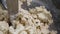 Close up for kneating dough in the industrial bakery dough mixer. Stock footage. Automatic equipment for pastry mixing