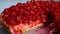 Close-up of a knife cutting a piece of a Fresh raspberry jelly-covered pie