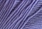 Close-up, knitting texture. The violet thread and knitting.