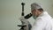 Close-up of a laboratory assistant in a medical uniform examines a biomaterial taken through a microscope. Laboratory medical rese