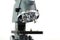 A close up laboratory multiple high magnification microscope toy replica against a white backdrop