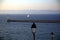 Close up of a lamppost, near the sea, with the background of the pier and a sailing boat, Parc National des Calanques, Marseille,