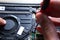 Close-up on a laptop cooler. The service technician removes the refrigerator because he wants to clean the dirt and dust