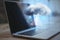 Close up of laptop on desktop with abstract hologram raining cloud on blurry background. Data, information leak, security and