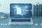 Close up of laptop on desktop with creative fingerprint hologram on blurry background. concept of fingerprint, biometrics,