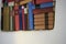 Close up of large assortment of german literature in white wall book shelf colourful hardcover books