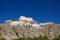CLOSE UP: Large Buddhist monastery sits atop the massive rocky mountain in Tibet