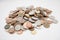 Close-up of large group of coins over white background