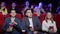 Close-up of a large group of people watching a scary movie in the cinema.