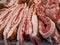 Close-up of large pieces of lard / bacon and pork meat at a market / grocery fair counter