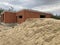 Close up of large pile of sand in countryside. Building materials on construction site outdoor. Concept of constructing