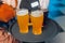 Close up on a large pint filled with unfiltered wheat ale, in front of 3 beer and cider glasses, with woman in