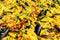 Close up of large portion of traditional Spanish paella dish freshly being cooked with seafood and rice in a frying pan at a stree