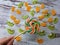 Close-up of a large round fruit candy on a background of slices of kiwi, mandarin