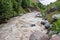 Close-up of a large turbulent flow of water in the river.