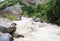 Close-up of a large turbulent flow of water in the river.