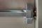 Close-up of latch and door handle of emergency exit. Push bar and rail for panic exit. Open one way door, Steel of handle for the