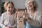 Close up laughing mature woman and granddaughter building wooden tower