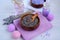 Close-up of lavender flowers in a wooden bowl on a lilac towel. Spa and beauty treatments concept