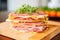 close-up of layered ham on a wooden board