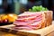 close-up of layered ham on a wooden board