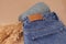 close-up leather empty tag or label on the back pocket of blue jeans on a vase of spool yarn with dry pampas grass