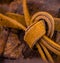 Close up of leather reins tied in a knot. Rich golden brown tones